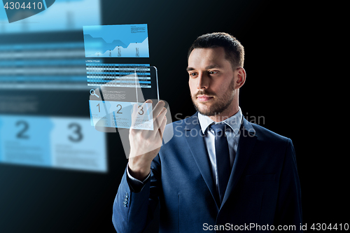 Image of businessman with smartphone and exchange charts