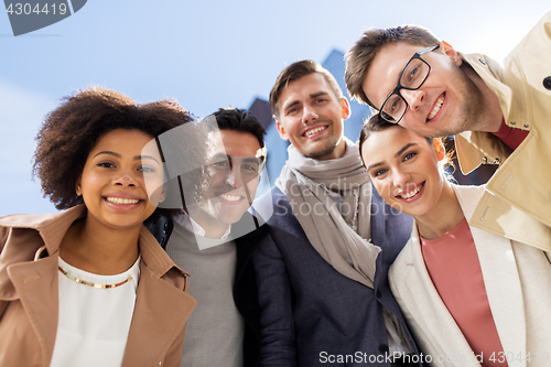 Image of group of happy people or friends on city street