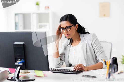 Image of stressed businesswoman with computer at office