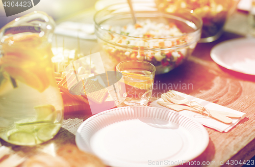 Image of table with food for dinner at summer garden party