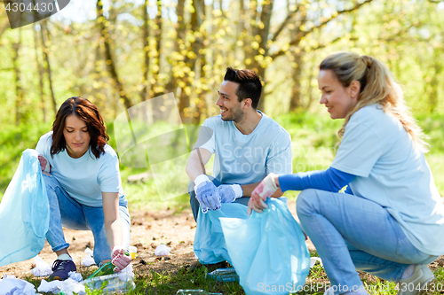 Image of volunteers with garbage bags cleaning park area