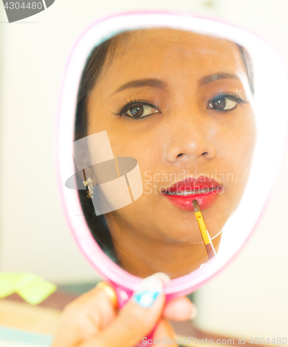 Image of Applying Lip Gloss In Mirror Shows Beauty