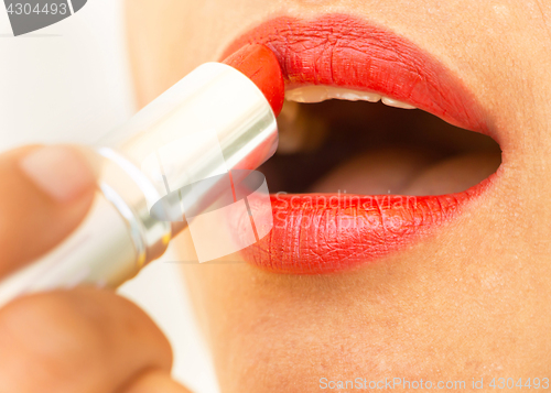 Image of Girl Applying Lipstick Shows Beauty And Glamour