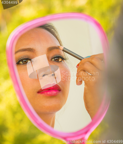 Image of Applying Eyebrows Makeup In Mirror Shows Cosmetics