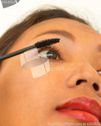 Image of Girl Applying Mascara On Her Eyelashes Uses Cosmetics