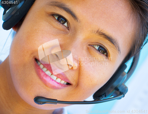 Image of Smiling Helpdesk Operator Girl Shows Call Center Assistance