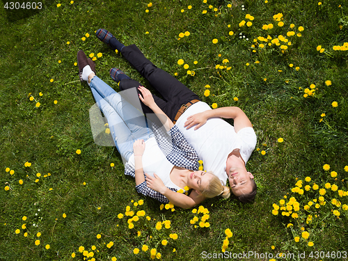 Image of man and woman lying on the grass