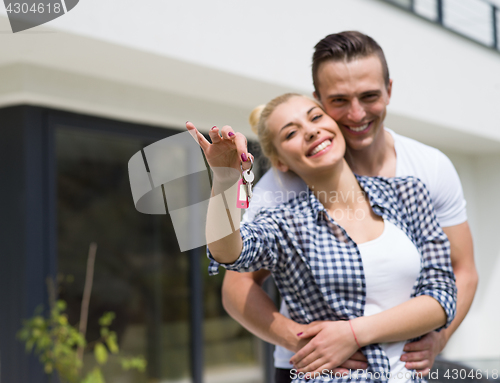 Image of couple hugging in front of  new luxury home