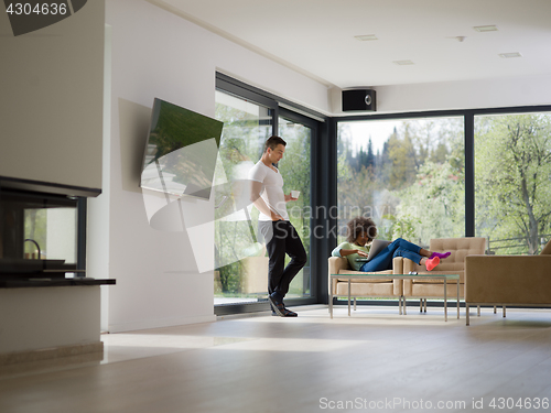 Image of multiethnic couple relaxing at  home with laptop computers