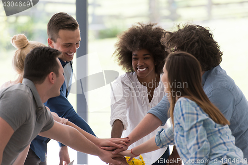 Image of multiethnic startup Group of young business people celebrating s