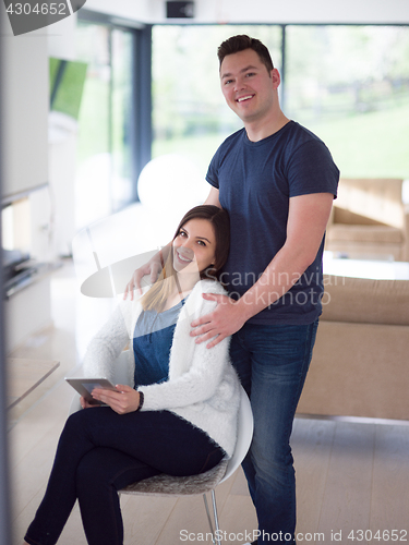 Image of couple using tablet at home