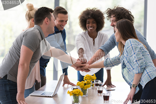 Image of multiethnic startup Group of young business people celebrating s