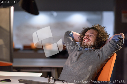 Image of businessman relaxing at the desk