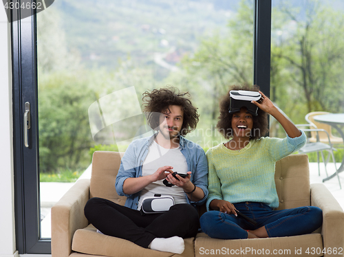 Image of Multiethnic Couple using virtual reality headset