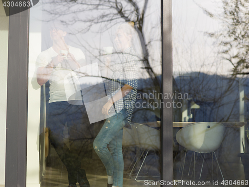 Image of young couple enjoying morning coffee