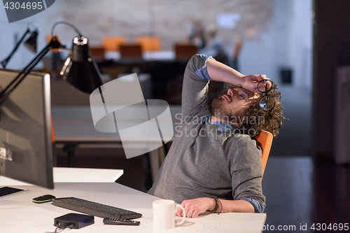 Image of businessman relaxing at the desk