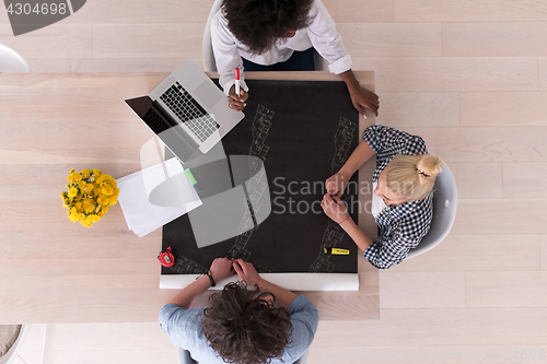 Image of top view of Multiethnic startup business team on meeting