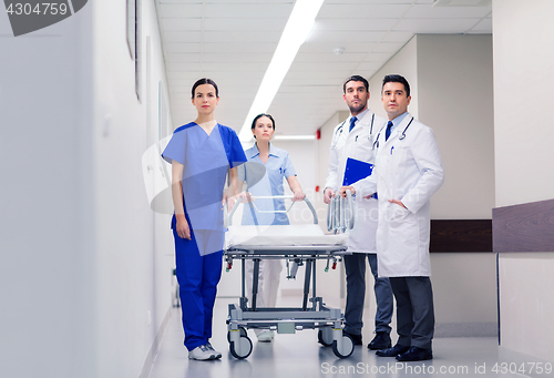 Image of group of doctors with gurney at hospital