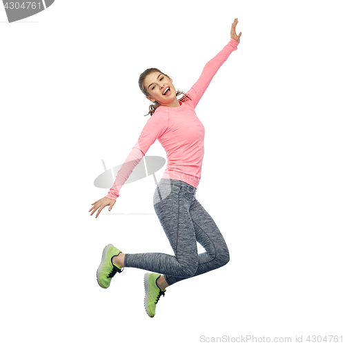 Image of happy smiling sporty young woman jumping in air