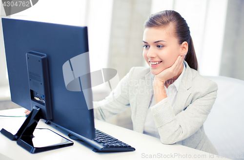 Image of businesswoman with computer in office