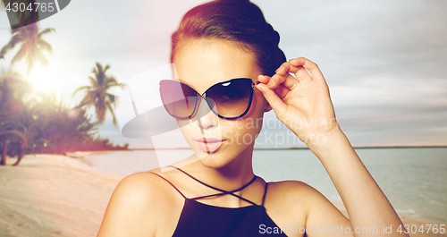 Image of beautiful young woman in elegant black sunglasses