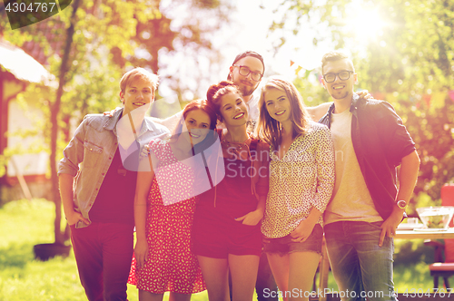 Image of happy teenage friends hugging at summer garden