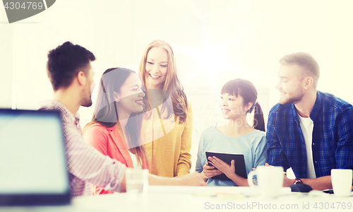 Image of happy creative team or students working at office