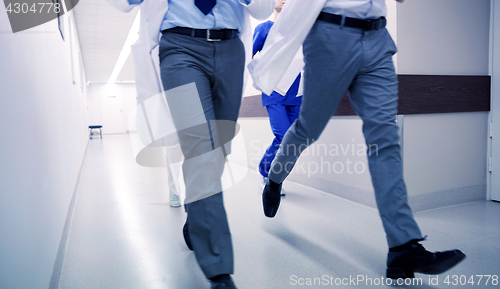 Image of close up of medics or doctors running at hospital