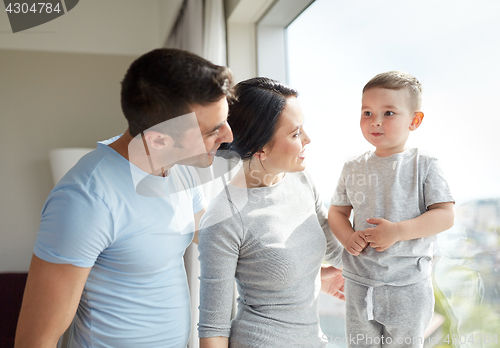 Image of happy family at window
