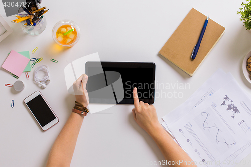 Image of hands with tablet pc and notebook at office table