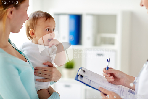 Image of woman, baby and doctor with clipboard at clinic