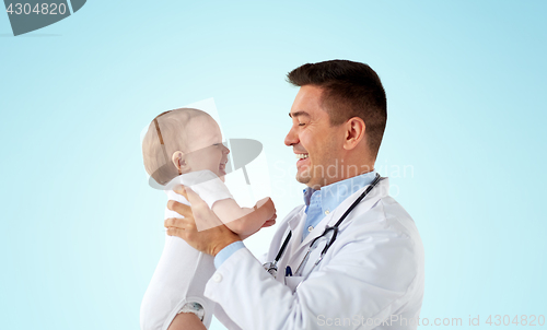 Image of happy doctor or pediatrician with baby over blue