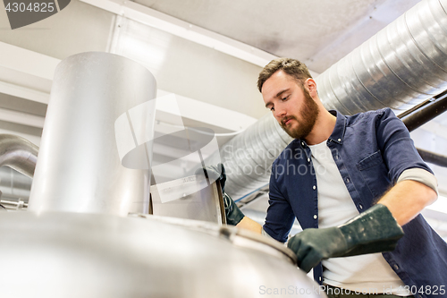 Image of man working at craft brewery or beer plant