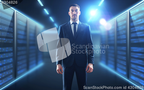 Image of businessman over server room background