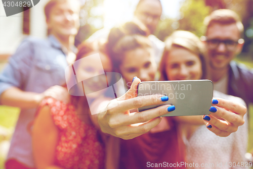 Image of friends with smartphone taking selfie at summer