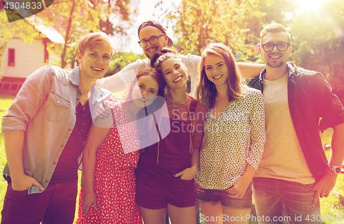 Image of happy teenage friends hugging at summer garden