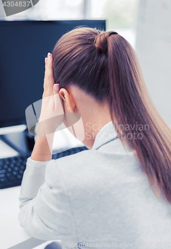 Image of stressed woman with computer