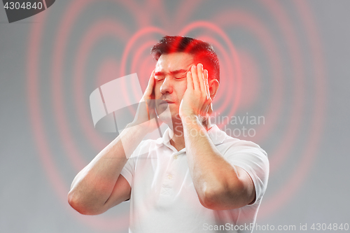 Image of unhappy man suffering from head ache