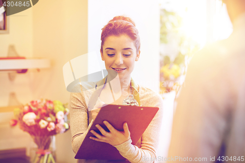 Image of florist woman and man making order at flower shop