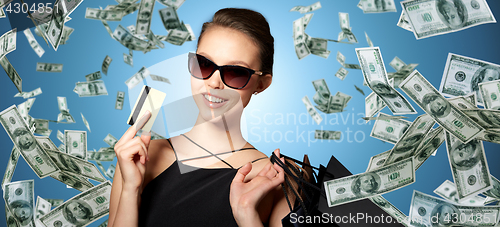 Image of happy woman with credit card and shopping bags