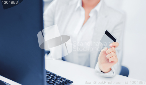 Image of businesswoman with laptop and credit card