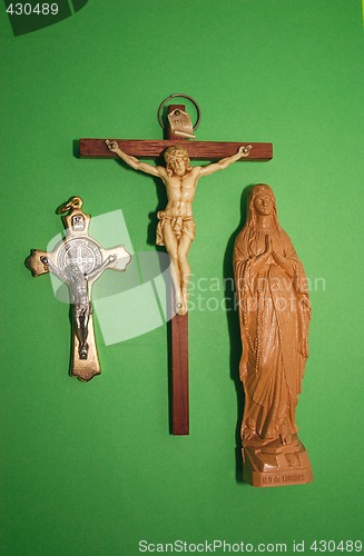 Image of two different crucifixes and Mary figurine