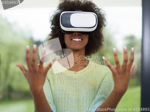 Image of black woman using VR headset glasses of virtual reality