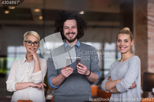 Image of group of Business People Working With Tablet in startup office