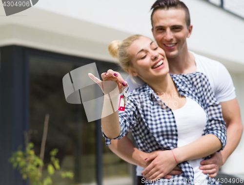 Image of couple hugging in front of  new luxury home