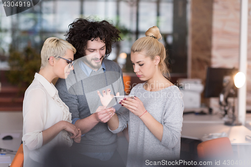 Image of group of Business People Working With Tablet in startup office