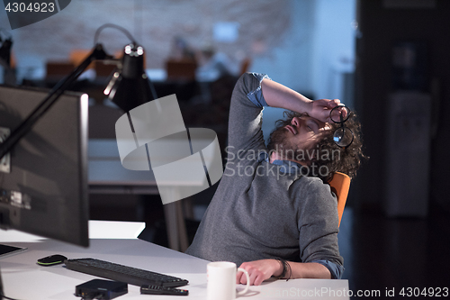 Image of businessman relaxing at the desk