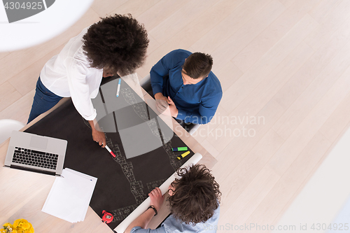Image of top view of Multiethnic startup business team on meeting