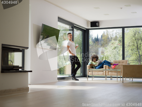 Image of multiethnic couple relaxing at  home with laptop computers