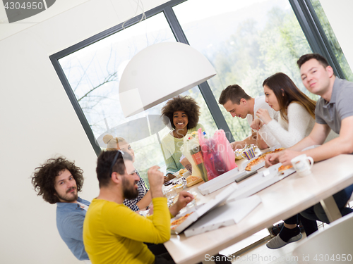 Image of multiethnic group of happy friends lunch time